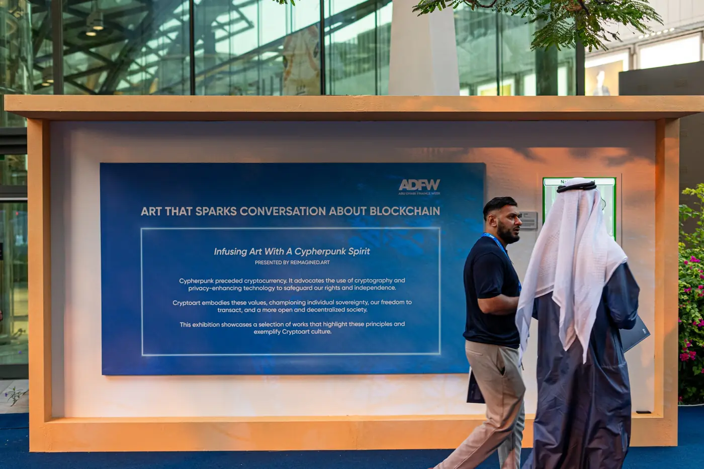 ADFW panel reading Art That Sparks Conversation About Blockchain, with delegates walking past