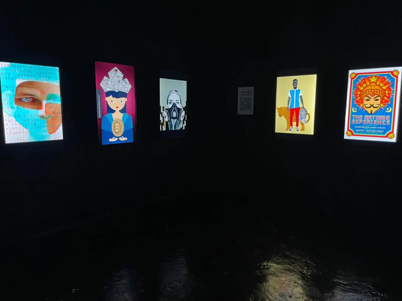 Five illuminated portrait-format works on a dark wall