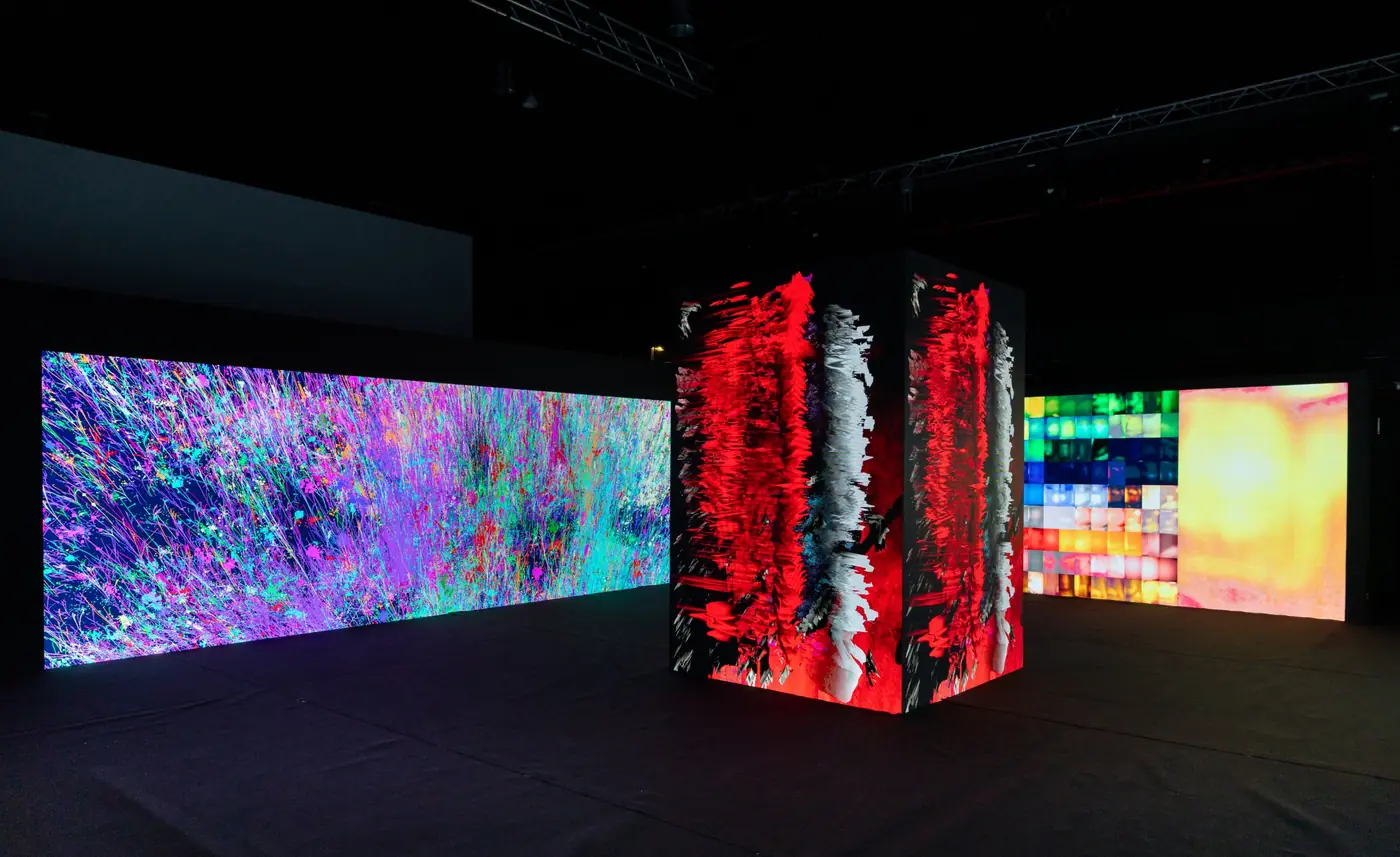 Generative artwork on a long LED wall beside the central column